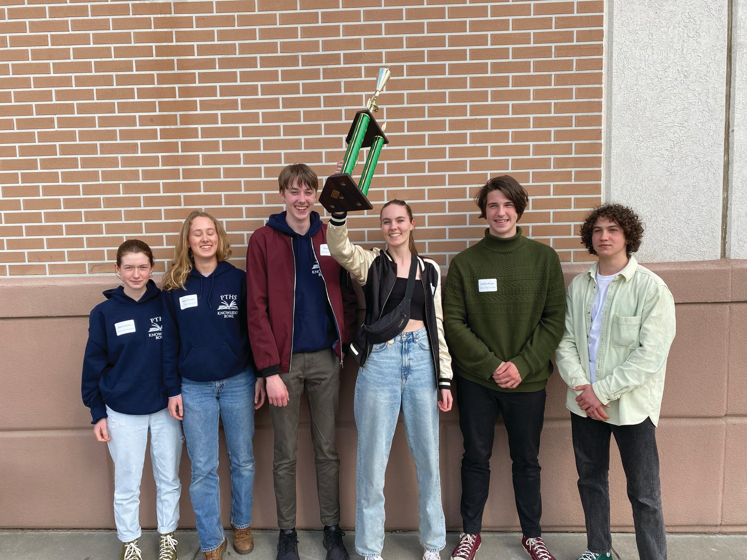 Port Townsend High School students Sophie Kunka, Maeve Kenney, Stuart Dow, Maya Dow, Lochlan Krupa, and Ashton Meyer-Bibbins celebrate with the second-place trophy after the Knowledge Bowl competition in Richland.